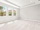 Well-lit bedroom with carpet flooring and three large windows at 23176 Pachino Way, Lutz, FL 33549