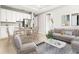 Open-concept kitchen and living area with modern appliances and stylish furniture at 23176 Pachino Way, Lutz, FL 33549