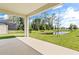 Covered patio overlooking a pond, showcasing a tranquil backyard landscape at 23176 Pachino Way, Lutz, FL 33549