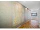 Hallway with wood flooring and large wall art at 1 Beach Se Dr # 1208, St Petersburg, FL 33701