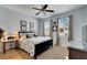 Main bedroom with king bed, ceiling fan, and en-suite bathroom at 108 Aberdeen Pond Dr, Apollo Beach, FL 33572