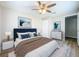 Comfortable bedroom with cozy carpet, neutral colored walls, a ceiling fan, and an ensuite bathroom at 1709 E Sitka St, Tampa, FL 33604