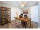 Comfortable office with laminate wood floors, a modern ceiling fan, shelving, and a large closet at 1709 E Sitka St, Tampa, FL 33604