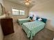 This bedroom features two twin beds, a ceiling fan and a window at 2385 Tahitian Ln # 63, Clearwater, FL 33763