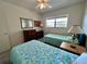 This bedroom includes two twin beds, a mirror, and dresser at 2385 Tahitian Ln # 63, Clearwater, FL 33763