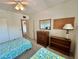 This bedroom includes two twin beds, a dresser and a mirror at 2385 Tahitian Ln # 63, Clearwater, FL 33763