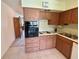 This kitchen features wood cabinets, an oven, and an electric stovetop at 2385 Tahitian Ln # 63, Clearwater, FL 33763