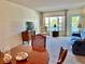 Well-lit living area with neutral carpet, a comfortable sofa, and a dining area with seating for four at 2385 Tahitian Ln # 63, Clearwater, FL 33763