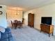 Inviting living room and dining area featuring comfortable seating, carpeted floors, and ample space at 2385 Tahitian Ln # 63, Clearwater, FL 33763