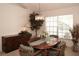 Elegant dining room with wood table and chairs, and large window at 2451 E Del Webb Blvd, Sun City Center, FL 33573