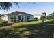 View of the home's backyard showing the patio and surrounding landscape at 2451 E Del Webb Blvd, Sun City Center, FL 33573