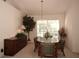 Bright dining room features a round table with green chairs and a large window at 2451 E Del Webb Blvd, Sun City Center, FL 33573