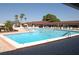 Community swimming pool with lounge chairs at 2451 E Del Webb Blvd, Sun City Center, FL 33573
