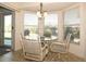 Bright breakfast nook with glass-top table and floral chairs near sliding door at 2451 E Del Webb Blvd, Sun City Center, FL 33573