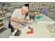 Stained glass studio with workbenches and tools at 2451 E Del Webb Blvd, Sun City Center, FL 33573