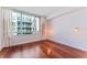 Bedroom with hardwood floors, large window, and city view at 912 Channelside Dr # 2607, Tampa, FL 33602