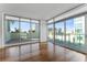 Bright living room with hardwood floors and sliding glass doors leading to a balcony at 912 Channelside Dr # 2607, Tampa, FL 33602