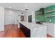Sleek kitchen featuring a large island, marble countertops, and a stylish green accent wall at 912 Channelside Dr # 2607, Tampa, FL 33602