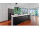 Modern kitchen with marble countertops, stainless steel appliances, and green geometric backsplash at 912 Channelside Dr # 2607, Tampa, FL 33602
