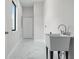 Laundry room with a utility sink and white tiled floor at 2316 S 46Th St, Tampa, FL 33619