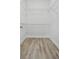 Spacious walk-in closet with wire shelving and wood-look floors at 2316 S 46Th St, Tampa, FL 33619