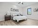 Bright bedroom with a queen bed, wood-look floors, and large window at 2316 S 46Th St, Tampa, FL 33619