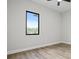 Spacious bedroom with wood-look floors and a large window at 2316 S 46Th St, Tampa, FL 33619