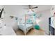 Cheerful bedroom with a canopy bed and fun, beachy decor at 2616 Garden Plum Pl, Odessa, FL 33556