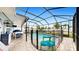 Screened pool area with patio furniture and safety fence at 2616 Garden Plum Pl, Odessa, FL 33556