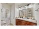 Double vanity bathroom with modern fixtures and updated cabinets at 2616 Garden Plum Pl, Odessa, FL 33556