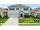 Two-story house with solar panels and a well-maintained lawn at 2616 Garden Plum Pl, Odessa, FL 33556