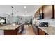 Open kitchen boasts granite countertops and modern cabinetry at 2616 Garden Plum Pl, Odessa, FL 33556