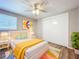 Bedroom with wood flooring, ceiling fan, and yellow bedding at 1709 E Sitka St, Tampa, FL 33604