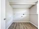 Empty laundry room with wood-look flooring and plumbing at 1709 E Sitka St, Tampa, FL 33604