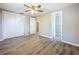 Bedroom with wood-look floors, ceiling fan and double sliding door closet at 1709 E Sitka St, Tampa, FL 33604