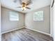Bedroom with wood-look floors, ceiling fan and two windows at 1709 E Sitka St, Tampa, FL 33604