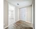 A hallway with wood-look floors and access to other rooms at 1709 E Sitka St, Tampa, FL 33604