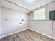 Laundry room with wood-look floors and window at 1709 E Sitka St, Tampa, FL 33604