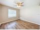 Spacious bedroom featuring wood-look floors and a ceiling fan at 1709 E Sitka St, Tampa, FL 33604