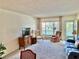 Spacious living room with a blue couch and two armchairs facing a balcony at 2385 Tahitian Ln # 63, Clearwater, FL 33763