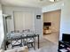 Dining area with table and chairs, view into kitchen at 2385 Tahitian Ln # 63, Clearwater, FL 33763