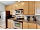 Stainless steel appliances and light wood cabinets in this kitchen at 108 Aberdeen Pond Dr, Apollo Beach, FL 33572