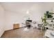 Bright home office featuring a desk, chair, and plants at 5806 Candytuft Place, Land O Lakes, FL 34639