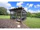 Screened-in pergola with seating for outdoor relaxation at 5806 Candytuft Place, Land O Lakes, FL 34639