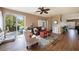 Living area features sliding doors to a patio, hardwood floors, and comfortable furniture at 5806 Candytuft Place, Land O Lakes, FL 34639
