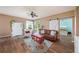 Living room with sliding barn door, hardwood floors, and a view of a bedroom at 5806 Candytuft Place, Land O Lakes, FL 34639