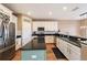 Spacious kitchen featuring granite countertops, stainless steel appliances, and light-colored cabinetry at 5806 Candytuft Place, Land O Lakes, FL 34639