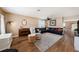Living room with hardwood floors, sectional sofa and fireplace at 5806 Candytuft Place, Land O Lakes, FL 34639