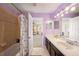 Double vanity bathroom with a tub and access to bedroom at 5806 Candytuft Place, Land O Lakes, FL 34639