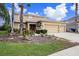 Two-story house with three car garage and landscaped yard at 5806 Candytuft Place, Land O Lakes, FL 34639